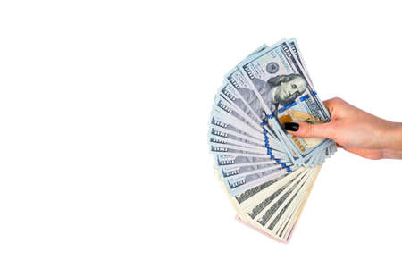 Hand with money isolated on white background. US Dollars in hand. Handful of money. Business woman offering money. Counting money. hand holds a bundle of dollar bills. Financial Credit concept.の写真素材