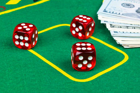 Dice rolls on a dollar bills Money. Green Poker table at the casino. Poker game concept. Playing a game with dice. Casino dice rolls. Concept for business risk. chance good luckの写真素材