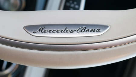 Imatra, Finland, September 3 2017: Close up view of a Mercedes-Benz logo on white leather steering wheel. Modern car interior details.のeditorial素材