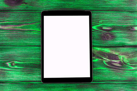 Tablet computer PC with blank screen mock up isolated on  green wooden table background. Tablet on wood table. tablet white screenの写真素材