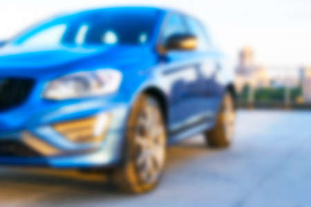 Blurred background of a A modern luxury car on the blur roof of the building. Modern car exterior detailsの写真素材