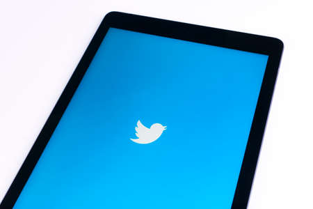 Sankt-Petersburg, Russia, November 9 2017: tab  on white table open Twitter app. Twitter is an online social networking and microblogging service .Twitter is a social microblogging network run by Twitter Inc.のeditorial素材