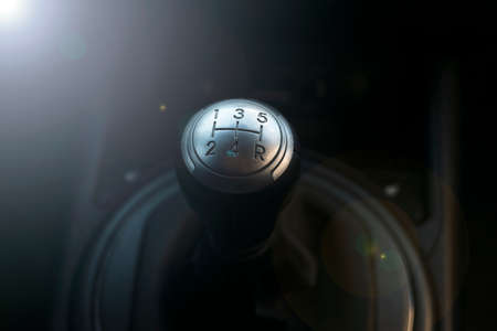 Close up view of a gear lever shift. Manual gearbox. Car interior details. Car transmission. Soft...