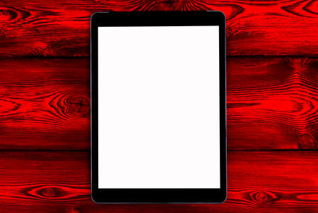 Tablet computer PC with blank screen mock up isolated on red wood table background. Tablet on wood table. tablet white screenの写真素材