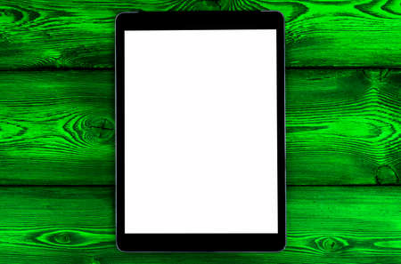 Tablet computer PC with blank screen mock up isolated on green wooden table background. Tablet on wood table. tablet white screenの写真素材