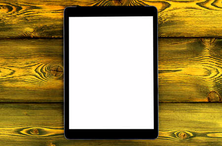 Tablet computer PC with blank screen mock up isolated on yellow wooden table background. Tablet computer on wood table. Tablet white screenの写真素材