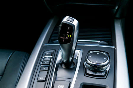 Automatic gear stick (transmission) of a modern car, multimedia and navigation control buttons. Car...