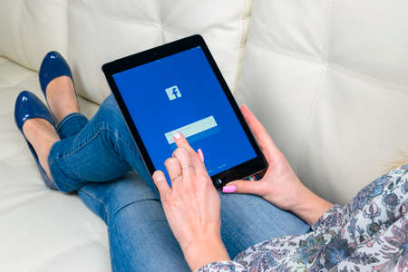 Sankt-Petersburg, Russia, December 3, 2017: Woman Hands using iPad pro with Facebook homepage on...