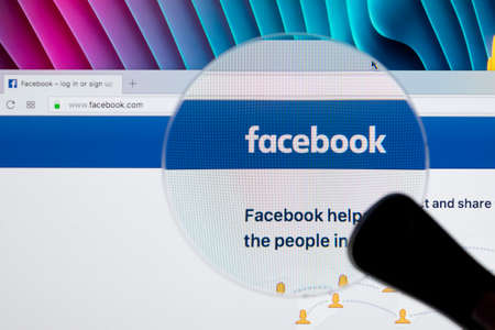 Sankt-Petersburg, Russia, December 4 ,2017: Facebook homepage, one of the biggest social network website. Homepage of Facebook.com on Apple iMac monitor screen under magnifying glass.のeditorial素材