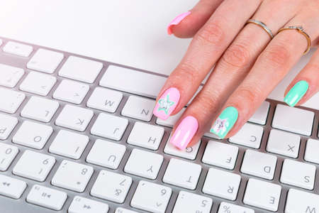 Closeup view of a business woman hand typing on wireless computer keyboard on office tableの写真素材