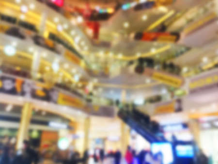 Blurred bokeh background with people in shopping mall with bokeh light. Blur image people in shopping mall. Shopping mall centre blur background with lightsの写真素材