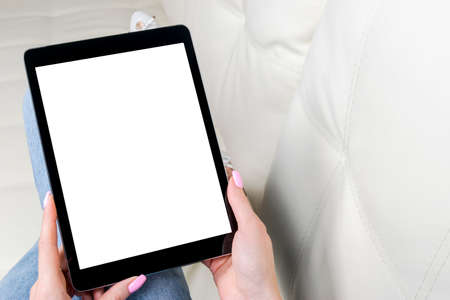 Woman hands holding and using tablet computer with isolated white screen. Blank empty screen. Copy Space for text. Isolated white screenの写真素材