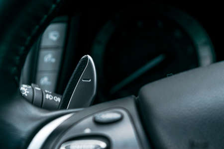 Manual gear changing stick on a car's steering wheel, Modern car interior details