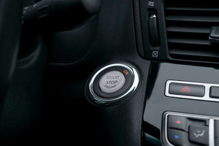 Car dashboard with focus on engine start stop button, Modern car interior details. start/stop