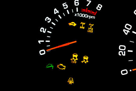 Car instrument panel, dashboard closeup with visible speedometer and fuel level. Modern steering...