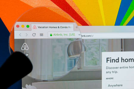 Sankt-Petersburg Russia, January 11, 2018: Apple iMac with Airbnb homepage on monitor screen under magnifying glass . Airbnb is online marketplace offering service to rent short-term lodging. Homepage of Airbnb.comのeditorial素材