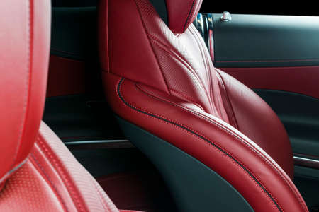 Modern Luxury car inside. Interior of prestige modern car. Comfortable leather red seats. Red...