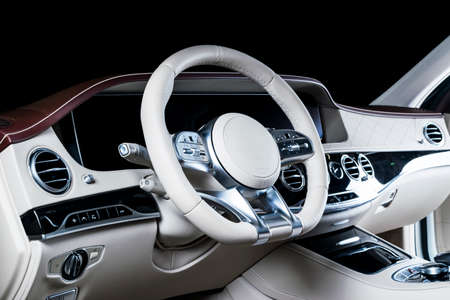 Modern Luxury car inside. Interior of prestige modern car. Comfortable leather seats. Red and white perforated leather cockpit. Steering wheel and dashboard. automatic gear stick shift. Car interiorの写真素材