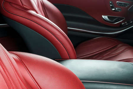 Modern Luxury car inside. Interior of prestige modern car. Comfortable leather red seats. Red perforated leather. Modern car interior detailsの写真素材