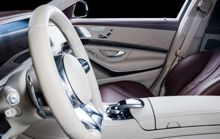 Modern Luxury car inside. Interior of prestige modern car. Comfortable leather seats. Red and white perforated leather cockpit. Steering wheel and dashboard. automatic gear stick shift. Car interiorの写真素材