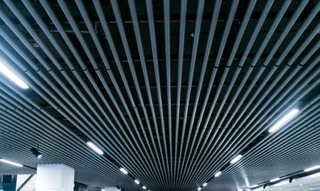 Lights and ventilation system in long line on ceiling of the dark office industrial building exhibition Hall Ceiling constructionの写真素材
