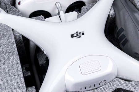 Sankt-Petersburg, Russia, March 11, 2018: The New Aircraft DJI Phantom 4 pro quadcopter drone with 4K video camera and wireless remote controller joystick in a box. Remote control. Aerial photographyのeditorial素材