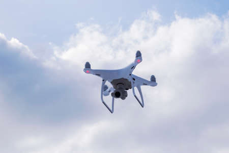 Sankt-Petersburg, Russia, March 12, 2018: The New Aircraft DJI Phantom 4 pro quadcopter drone with 4K video camera and wireless remote controller flying in the sky. Aerial photographyのeditorial素材