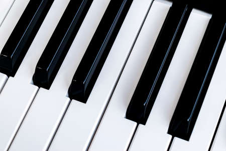 Top view of piano keys. Close-up of piano keys. Close frontal view. Piano keyboard with selective focus. Diagonal view. Piano keyboard perspectiveの写真素材