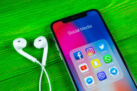 Sankt-Petersburg, Russia, April 5, 2018: Apple iPhone X with icons of social media facebook, instagram, twitter, snapchat application on screen. Social media icons. Social network. Social mediaのeditorial素材