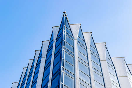 Detail of modern office building exterior. Business buildings skyline looking up with blue sky....