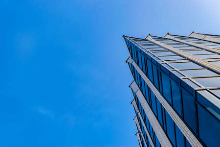 Detail of office building exterior. Business buildings skyline looking up with blue sky. Modern architecture apartment. High tech exterior. Reflective buildings. Office Skyscraper. Glass office.のeditorial素材