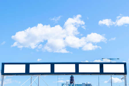 Blank white billboard on city street. In the background street and building. Mock up. Poster on street. Empty space for text. Copy space. Isolated white screen. Mockup for advertising bannersの写真素材