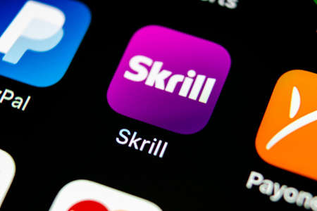 Sankt-Petersburg, Russia, May 10, 2018: Skrill application icon on Apple iPhone X smartphone screen close-up. Skrill app icon. Skrill is an online electronic finance payment system.のeditorial素材