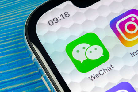 Sankt-Petersburg, Russia, June 20, 2018: Wechat messenger application icon on Apple iPhone X smartphone screen close-up. Wechat messenger app icon. Social media network.のeditorial素材