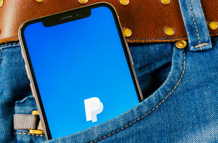 Sankt-Petersburg, Russia, April 14, 2018: PayPal application icon on Apple iPhone X smartphone screen close-up in jeans pocket. PayPal app icon. PayPal is an online electronic finance payment system.のeditorial素材