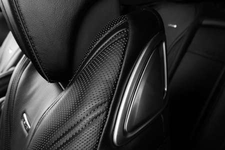 Modern Luxury car inside. Interior of prestige modern car. Comfortable leather red seats. Perforated...