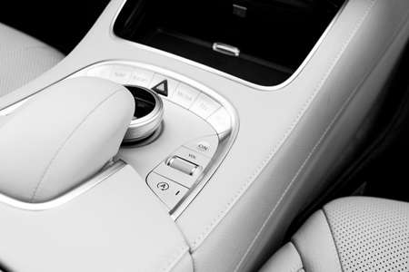 Media volume and navigation control buttons of a Modern car. Car interior details. White leather interior of the luxury modern car. Modern car interior. Car detailing. Black and whiteの写真素材