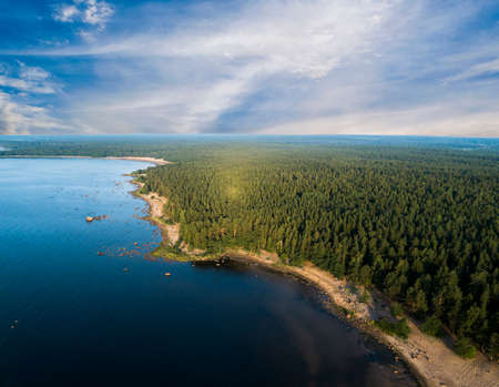 Aerial view of seashore with beach, lagoons and coral reefs. Coastline with sand and water. Tropical landscape. Aerial photography. Birdseye. Sea, beach, sky, clouds.の写真素材