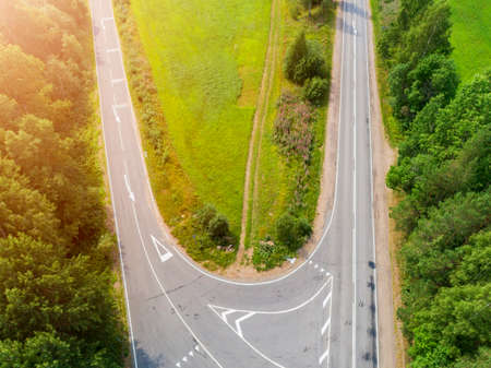 Aerial view of highway. Aerial view of a country road. Car passing by. Aerial road. Aerial view...