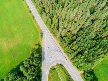 Aerial view of highway with car. Aerial view of a country road with moving car. Car passing by....