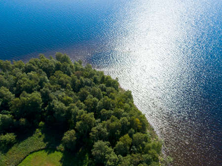 Aerial view of seashore with beach, lagoons and coral reefs. Coastline with sand and water. Tropical landscape. Aerial photography. Birdseye. Sea, beach, sky, clouds.の写真素材