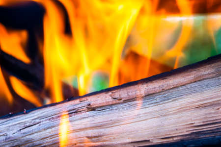 Burning firewood in the fireplace close up, BBQ fire, charcoal background. Charcoal fire with sparksの写真素材