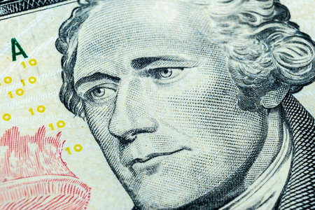 Close up view Portrait of Alexander Hamilton on the one ten dollar bill. Background of the money. 10 dollar bill with Alexander Hamilton eyes macro shot. Money background. Face portraitのeditorial素材