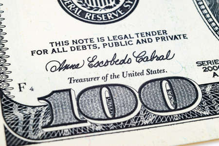 Macro shot image of the corner of a 100 dollar bill banknotes. Concept of financial success. Background of 100 dollar bills. One hundred dollars.の写真素材