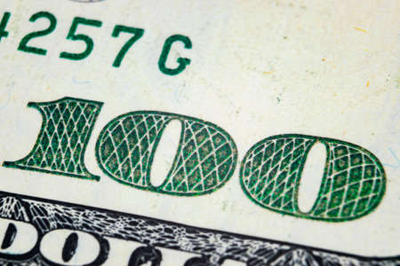 Macro shot image of the corner of a 100 dollar bill banknotes. Concept of financial success. Background of 100 dollar bills. One hundred dollars.の写真素材