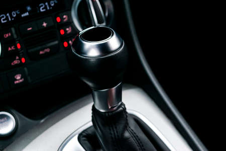 Close up view of a gear lever shift. Manual gearbox. Car interior details. Car transmission. Soft...