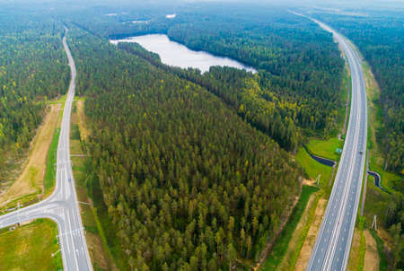 Aerial view of highway in city. Cars crossing interchange overpass. Highway interchange with...