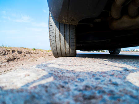 Tire and alloy wheel of a modern car on the ground. Car exterior details. Car detailing.