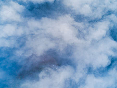 Aerial view White clouds in blue sky. Top view. View from drone. Aerial bird's eye view. Aerial top view cloudscape. Texture of clouds. View from above. Sunrise over cloudsの写真素材