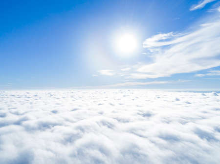 Aerial view White clouds in blue sky. Top view. View from drone. Aerial bird's eye view. Aerial top view cloudscape. Texture of clouds. View from above. Sunrise over cloudsの写真素材